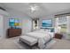 Main bedroom with beach artwork, a big bed and plenty of closet space at 2507 Caribe Dr, The Villages, FL 32162