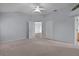 Spacious main bedroom features carpet, a ceiling fan, a closet, and a glimpse into the ensuite bathroom at 2507 Caribe Dr, The Villages, FL 32162