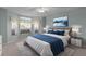 Bright main bedroom featuring a big bed, a ceiling fan, and big windows at 2507 Caribe Dr, The Villages, FL 32162