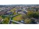 Aerial view of a well-maintained backyard with a trampoline and carport in a residential neighborhood at 26008 Singing Lark Ct, Leesburg, FL 34748