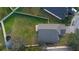 Overhead view of a fully fenced backyard with lush lawn, patio, and trampoline at 26008 Singing Lark Ct, Leesburg, FL 34748