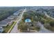 Aerial shot of a community pool with lush greenery and mature landscaping in a residential area at 26008 Singing Lark Ct, Leesburg, FL 34748