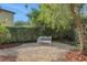 Landscaped backyard with a tranquil seating area at 30138 Losino Cv, Mount Dora, FL 32757