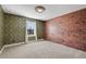 Bedroom with brick and wallpaper accents and window at 30138 Losino Cv, Mount Dora, FL 32757