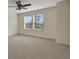 Bright bedroom featuring two windows and carpet flooring at 30138 Losino Cv, Mount Dora, FL 32757