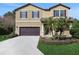 Two-story house with a large driveway and landscaping at 30138 Losino Cv, Mount Dora, FL 32757