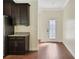Dark wood cabinetry and granite countertops in kitchen at 30138 Losino Cv, Mount Dora, FL 32757