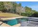 Inviting pool with patio furniture and lush landscaping at 30138 Losino Cv, Mount Dora, FL 32757