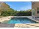 Inviting pool with patio furniture and lush landscaping at 30138 Losino Cv, Mount Dora, FL 32757
