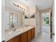 Double sink bathroom with view into a bedroom at 3463 Creek Run Ln, Eustis, FL 32736