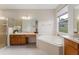 Elegant bathroom with corner tub, double vanity, and shower at 3463 Creek Run Ln, Eustis, FL 32736