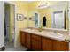 Double vanity bathroom with yellow walls at 3463 Creek Run Ln, Eustis, FL 32736