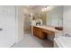 Bathroom with shower, double vanity, and large mirror at 3463 Creek Run Ln, Eustis, FL 32736