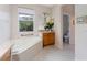 Bathroom with corner soaking tub and separate toilet area at 3463 Creek Run Ln, Eustis, FL 32736
