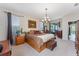Bright bedroom with king-size bed and sliding doors to patio at 3463 Creek Run Ln, Eustis, FL 32736