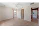 Neutral-toned bedroom with double doors leading to the bathroom at 3463 Creek Run Ln, Eustis, FL 32736