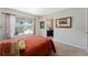 Comfortable bedroom with red bedding and adjacent office at 3463 Creek Run Ln, Eustis, FL 32736