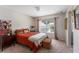 Spacious bedroom with orange bedding and wood accents at 3463 Creek Run Ln, Eustis, FL 32736