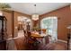 Formal dining room with wood floors, a large window, and a chandelier at 3463 Creek Run Ln, Eustis, FL 32736