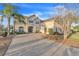 This home boasts a double-entry front door, brick driveway, and well-maintained landscaping at 3463 Creek Run Ln, Eustis, FL 32736