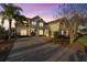 This home boasts a double-entry front door, brick driveway, and well-maintained landscaping at 3463 Creek Run Ln, Eustis, FL 32736