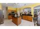 Kitchen with island, stainless steel appliances, and wood cabinets at 3463 Creek Run Ln, Eustis, FL 32736
