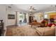 Bright living room featuring hardwood floors, a comfortable couch, and access to the backyard at 3463 Creek Run Ln, Eustis, FL 32736