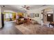 Open living area with hardwood floors, neutral walls, and views into the kitchen and dining area at 3463 Creek Run Ln, Eustis, FL 32736