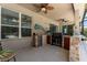 Outdoor kitchen with built-in grill, mini-fridge, and stone countertops at 3463 Creek Run Ln, Eustis, FL 32736
