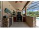 Outdoor kitchen with built-in grill and stone countertops at 3463 Creek Run Ln, Eustis, FL 32736