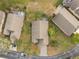 Aerial shot showcasing the home's layout, neighboring houses, and a glimpse of the private pool at 3518 Westerham Dr, Clermont, FL 34711