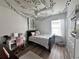 Bedroom with a bed, desk, and decorative wall hangings at 4813 Waters Gate Dr, Tavares, FL 32778
