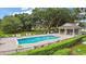 Community pool with lounge chairs and a shaded area at 4813 Waters Gate Dr, Tavares, FL 32778