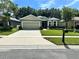 One-story house with a two-car garage and landscaped lawn at 4813 Waters Gate Dr, Tavares, FL 32778