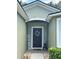 Inviting front door entrance with a decorative wreath and welcome sign at 4813 Waters Gate Dr, Tavares, FL 32778