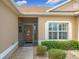 Front entry with screened porch and well-manicured landscaping at 5110 Chanticleer Dr, Leesburg, FL 34748