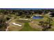 Golf course with sand traps, pond, and homes at 5312 Meadow Hill Loop, Lady Lake, FL 32159
