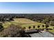 Aerial view of golf course, tennis courts, and clubhouse at 5312 Meadow Hill Loop, Lady Lake, FL 32159