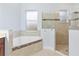 Bathroom featuring a soaking tub with tile surround and a glass-enclosed shower at 5312 Meadow Hill Loop, Lady Lake, FL 32159