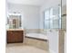 Bright bathroom featuring a soaking tub with tile surround and a glass-enclosed shower at 5312 Meadow Hill Loop, Lady Lake, FL 32159