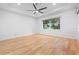 Bright bedroom featuring hardwood floors and a large window at 5312 Meadow Hill Loop, Lady Lake, FL 32159