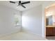 Bedroom with window, ceiling fan and bathroom access at 5312 Meadow Hill Loop, Lady Lake, FL 32159