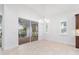 Elegant dining room with chandelier and access to patio at 5312 Meadow Hill Loop, Lady Lake, FL 32159