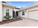 Charming home with manicured landscaping, featuring a brick walkway leading to the entrance at 5312 Meadow Hill Loop, Lady Lake, FL 32159