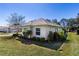 Well-maintained home exterior with manicured landscaping and a lush green lawn at 5312 Meadow Hill Loop, Lady Lake, FL 32159