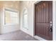 Inviting front entrance features a beautiful door, decorative windows, and a brick-paved landing at 5312 Meadow Hill Loop, Lady Lake, FL 32159