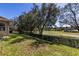 Backyard view showcasing a scenic golf course and mature trees at 5312 Meadow Hill Loop, Lady Lake, FL 32159
