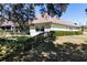 Side view showcasing the home's exterior, fenced backyard, and landscaping at 5312 Meadow Hill Loop, Lady Lake, FL 32159