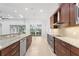 Modern kitchen with stainless steel appliances, granite counters, and view to the outdoor space at 5312 Meadow Hill Loop, Lady Lake, FL 32159