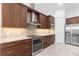 Gourmet kitchen with granite counters, stainless steel appliances, and ample cabinet space at 5312 Meadow Hill Loop, Lady Lake, FL 32159